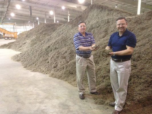 Mark Brown, right, the chief executive officer of WastAway, holds some of the fluff product made from trash while he and Terry Moore, the company's chief business development officer, stand before piles of fluff at their warehouse in Warren County. WastAway uses the fluff to create fuel and potting soil products. (Photo: Scott Broden/DNJ)